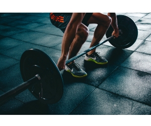 Man Lifting Weights in a Gym